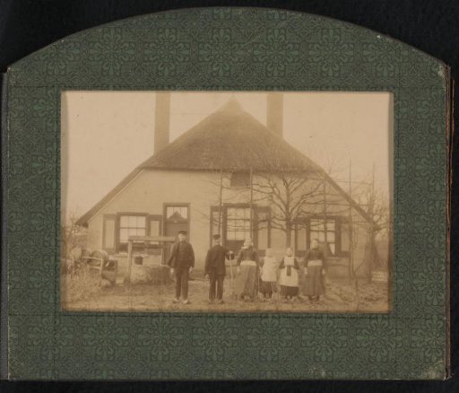 Five persons in front of a house