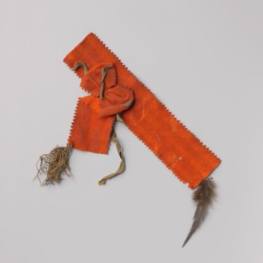 Orange armlet of cloth with gold braid and fringe