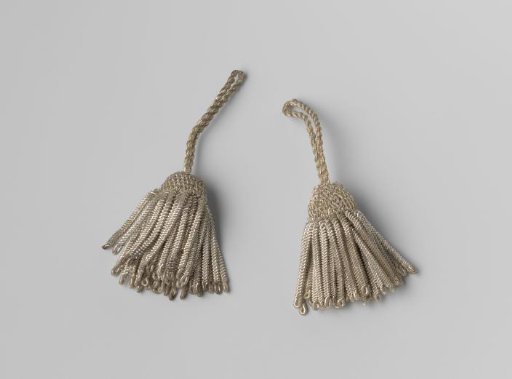 Silver-colored hat tassels