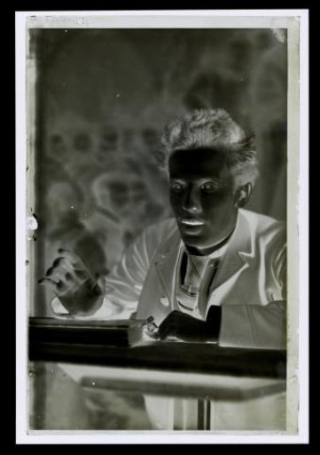 Unknown Young Man Behind a Table
