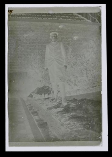 Portrait of an unknown standing boy in a garden with snow