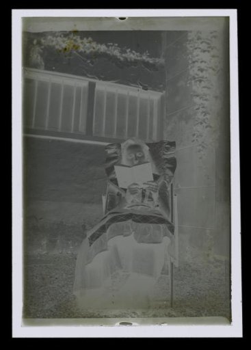 Portrait of an unknown woman, reading in a garden