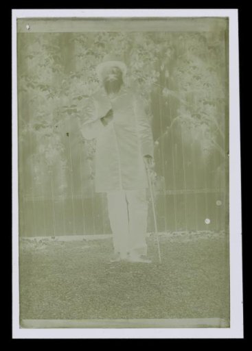 Portrait of an unknown man with a beard, standing in a garden