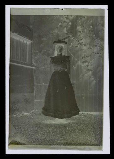 Portrait of an unknown woman with a hat in a garden