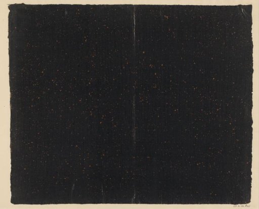 Orange speckled black paper