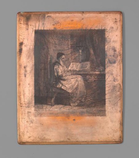 Old Cleric Sitting at a Table with Bible and Crucifix