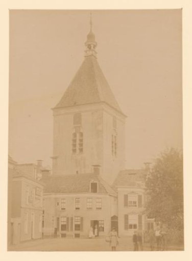 Street view with the freestanding tower of the Dutch Reformed Church in Winschoten