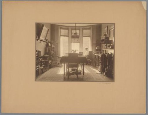 Interior of a house with a reading woman