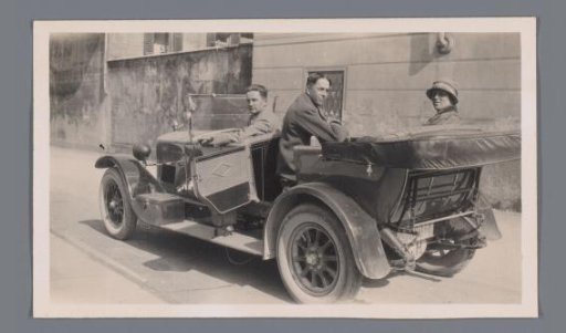 Group portrait of unknown persons in a car