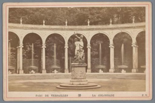 Row of columns with a statue in the Gardens of Versailles