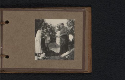 Family drinking tea outdoors