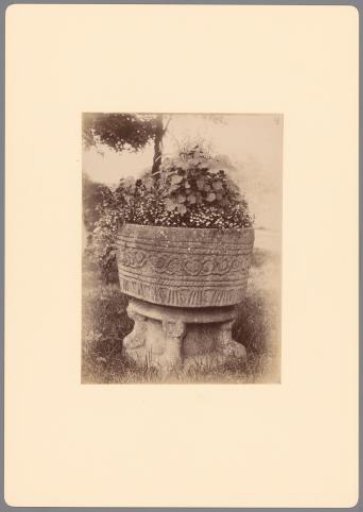 Baptismal font with flowers in the garden in Hattem