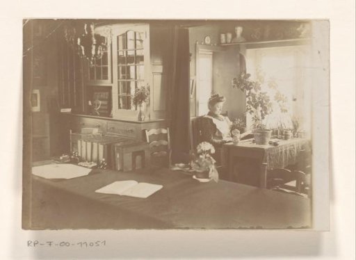 Interior with a woman reading at a table