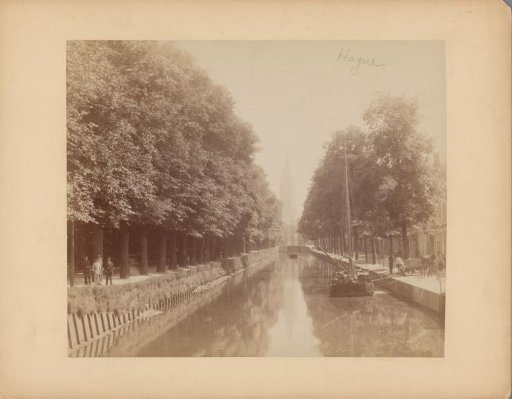 View of a canal with a church tower in The Hague