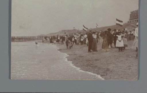 People on the beach with Dutch flags