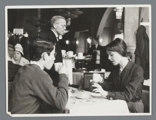 Sylvia Willink with an unknown young man in a restaurant