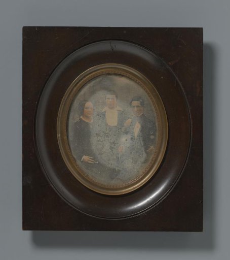 Group portrait of an unknown man, woman, and child