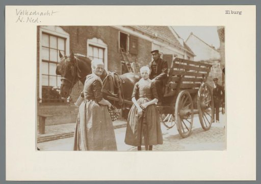 Street view in Elburg with two women in the foreground and a horse-and-cart
