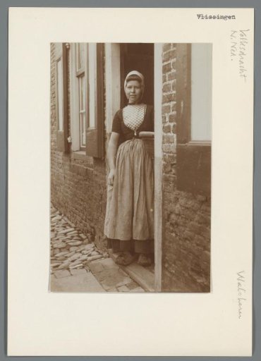 Woman in Walcheren costume standing in a doorway