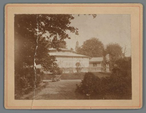 View of a tea house with a wheelbarrow in the foreground