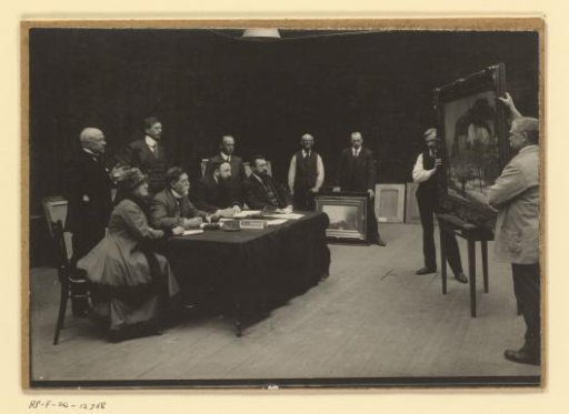 Group of artists and teachers judging a painting