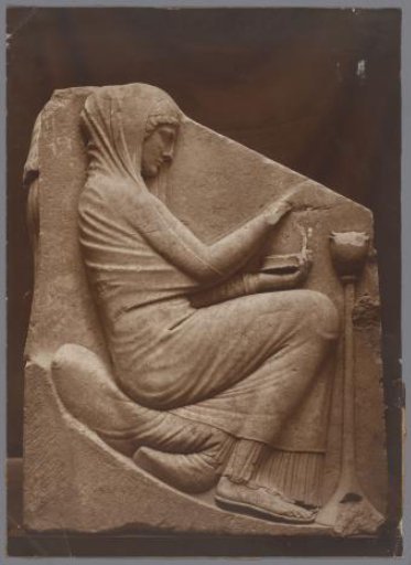 Antique stele with female figure