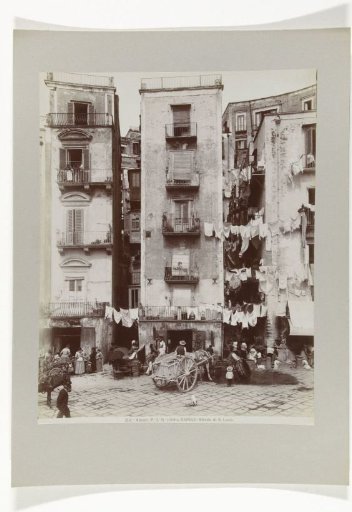 Strada di Santa Lucia in Naples with people on the street and drying laundry