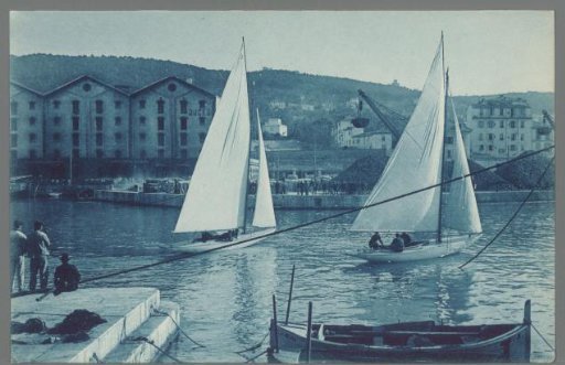 View of a harbor with sailing ships