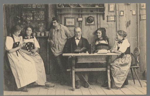 Six people, four of whom in regional costume, in a living room in the Bernese Oberland