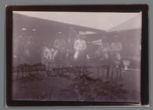 Group portrait of unknown men with servants, Dutch East Indies