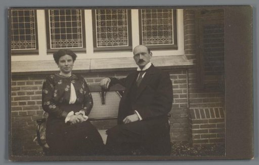 Portrait of an Unknown Man and Woman on a Bench in Front of a House