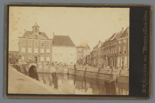 Canal with town hall and city gate, Netherlands