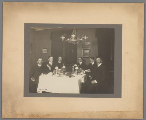 Group portrait of six unknown young men at a table