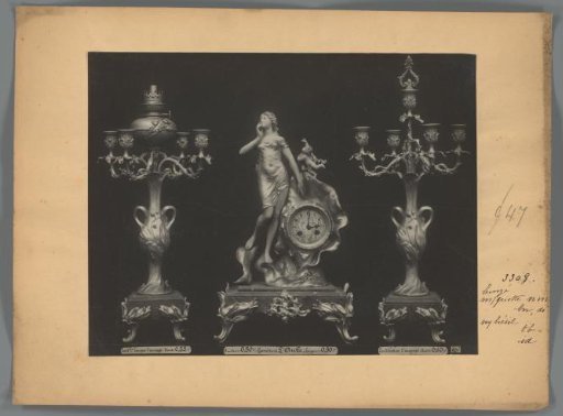 Photographic reproduction of two candlesticks and a clock