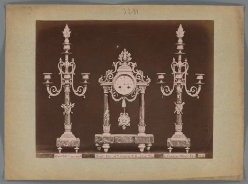Photographic reproduction of two candlesticks and a clock