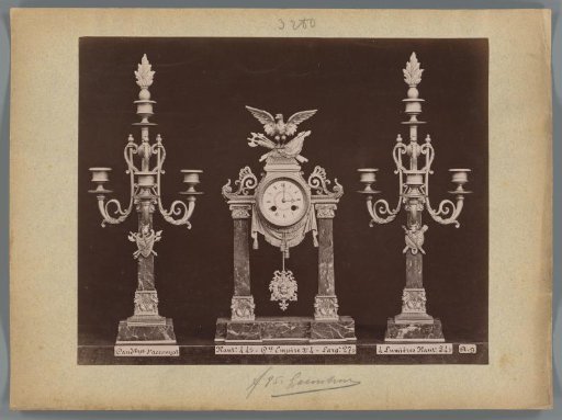 Photographic reproduction of two candlesticks and a clock in the Empire style with an eagle