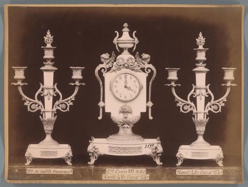 Photographic reproduction of two candlesticks and a clock with decoration in Louis XVI style