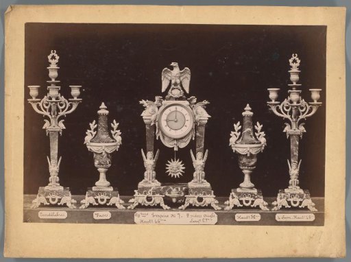 Photographic reproduction of two candlesticks, two vases and a clock with an eagle