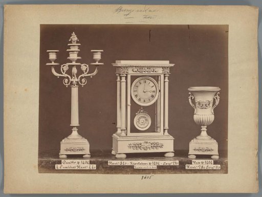Photographic reproduction of a candlestick, a clock of gold and bronze and a vase