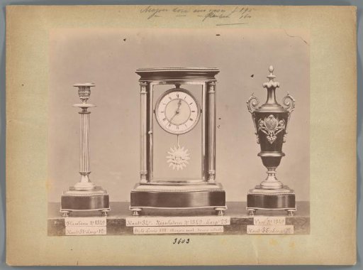 Photographic reproduction of a candlestick, clock with mahogany and gilding and a vase