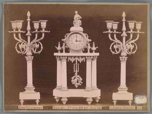 Photographic reproduction of two candlesticks and a clock with a female figure and decoration in Louis XVI style