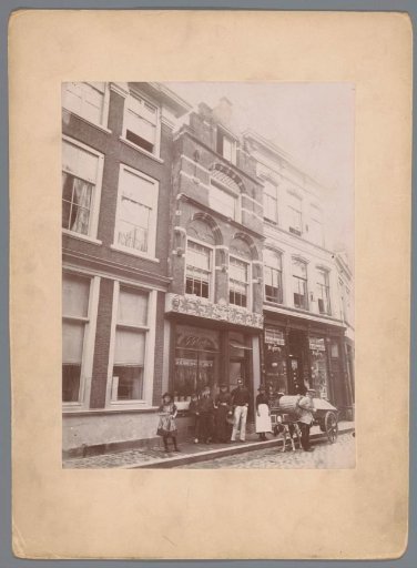 View of building Steegoversloot 9 in Dordrecht with a group of people and a dog cart