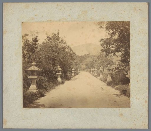 Sandy path flanked by lanterns (possibly) in Japan