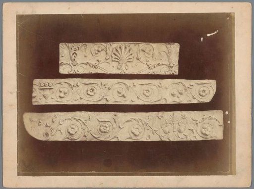 Three reliefs with floral motifs and a shell