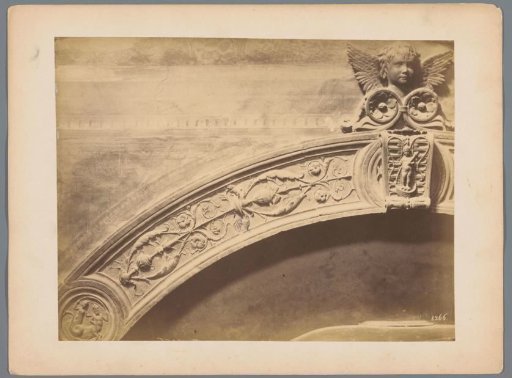 Part of an archivolt with reliefs of fantasy creatures and a cherub (possibly) in Italy