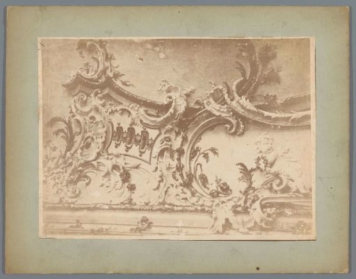 Part (possibly) of a ceiling ornament with arabesques and a putto