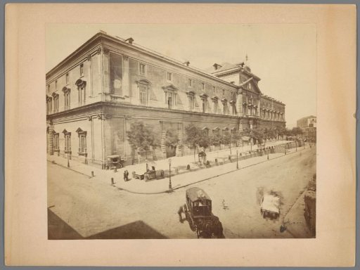 Facade of a building with a horse-drawn carriage in the foreground, presumably in Southern Europe