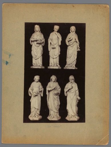 Six sculptures of women and a chained man