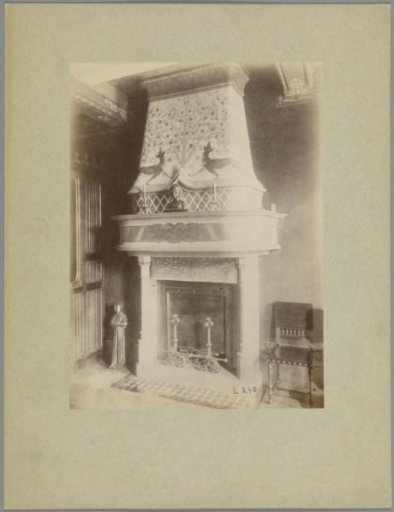 Bust of a child on a mantelpiece decorated with two dogs under a fruit tree