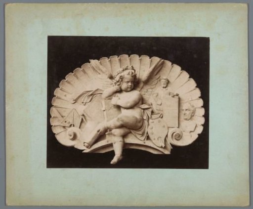Sculpture of a shell form containing a putto surrounded by mathematical attributes, a painter's palette, a bust, and a sculptor